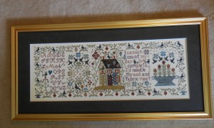 Loose Feathers Mystery Sampler framed.