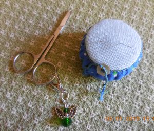 Pincushion and angel scissor fob.